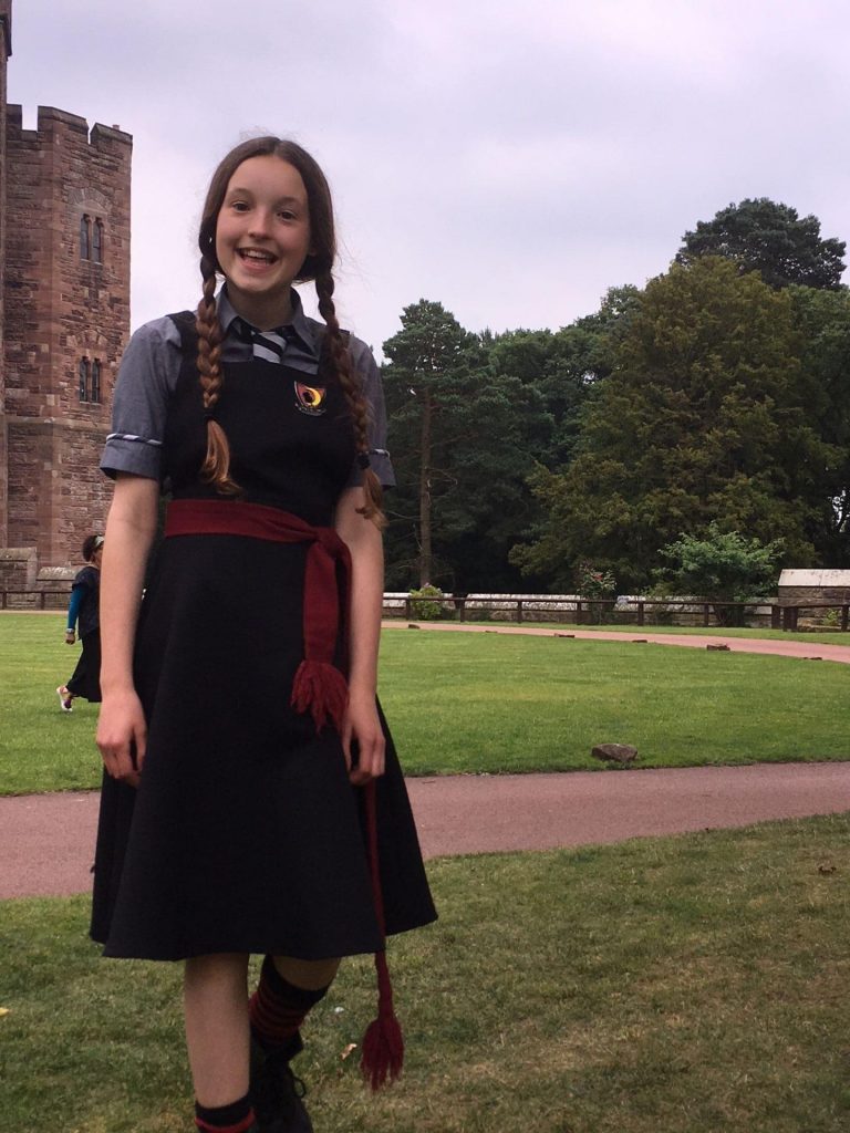 King's InterHigh pupil & actress, Bella Ramsey, wearing school uniform with long plaits in her role as Mildred Hubble in the Worst Witch.